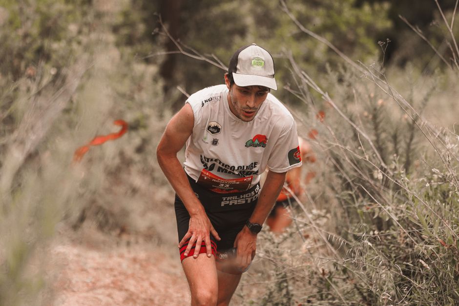 Athlete participates in a challenging trail race outdoors, showing determination and endurance.